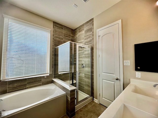 bathroom featuring tile patterned flooring, a shower stall, vanity, and a bath