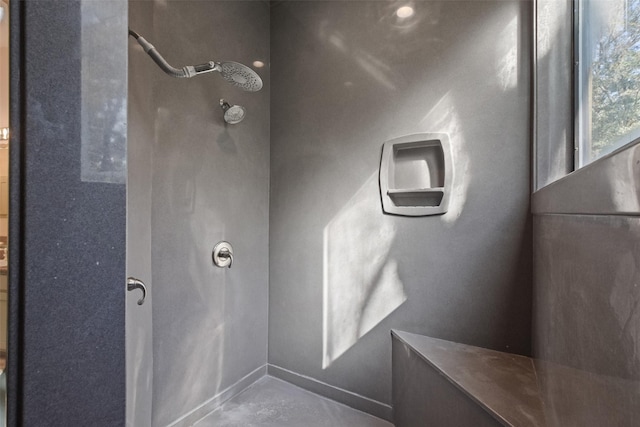 bathroom featuring concrete floors and walk in shower