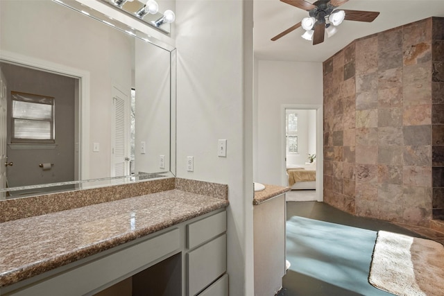 bathroom featuring ceiling fan, vanity, and tile walls