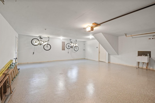 garage with baseboards and a garage door opener