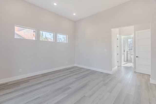 spare room with recessed lighting, light wood-style flooring, and baseboards