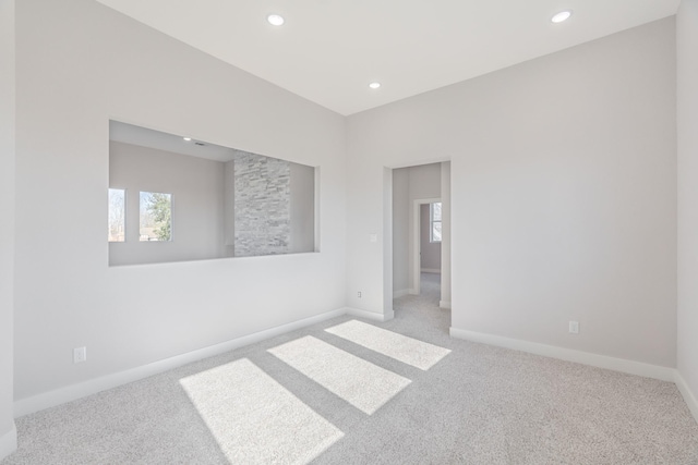 unfurnished room with recessed lighting, carpet, and baseboards