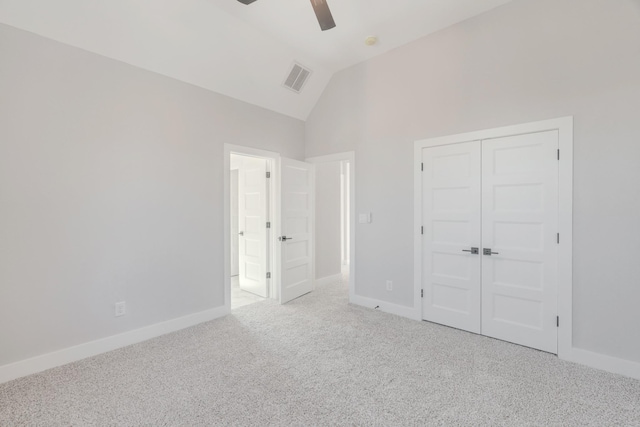 unfurnished bedroom with light colored carpet, visible vents, lofted ceiling, and baseboards