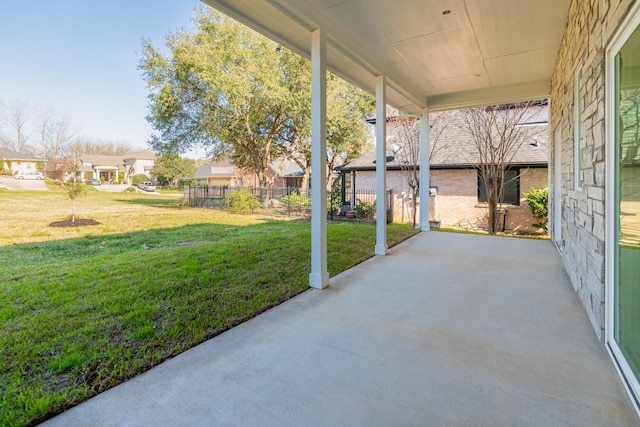 view of patio featuring a residential view and fence