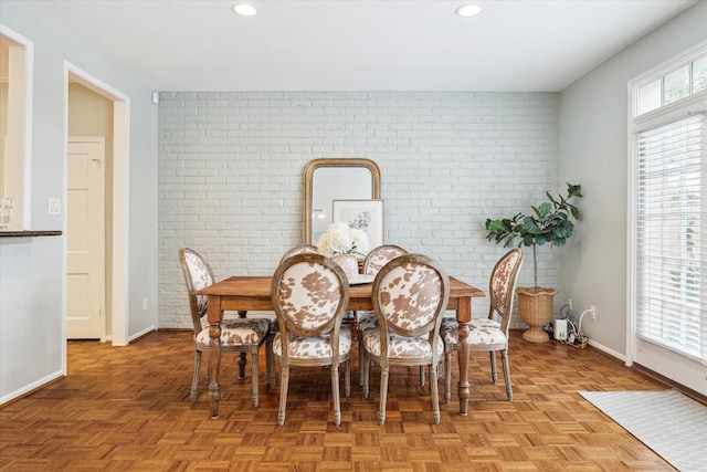 dining space with recessed lighting, brick wall, and baseboards