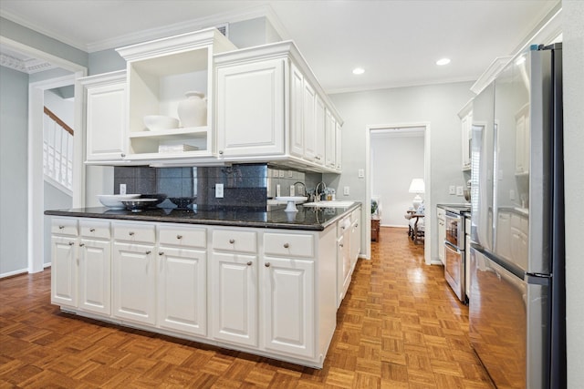 kitchen with open shelves, white cabinetry, stainless steel appliances, and decorative backsplash