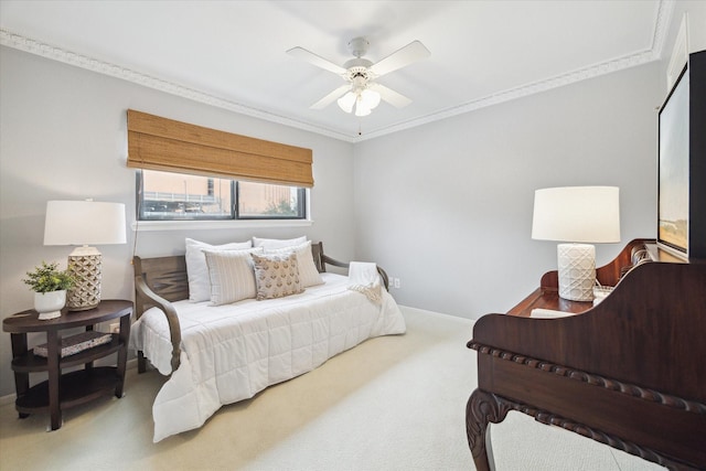 carpeted bedroom featuring ornamental molding, a ceiling fan, and baseboards