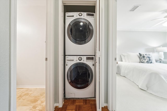 washroom with laundry area, visible vents, and stacked washer and clothes dryer