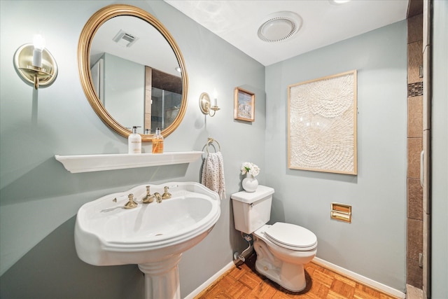 bathroom featuring baseboards, visible vents, and toilet