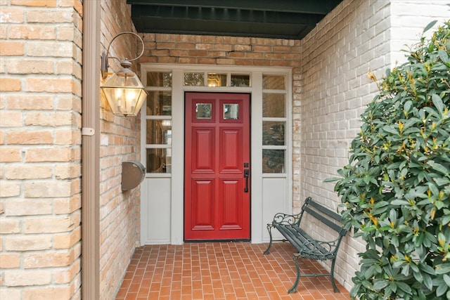 view of exterior entry with brick siding