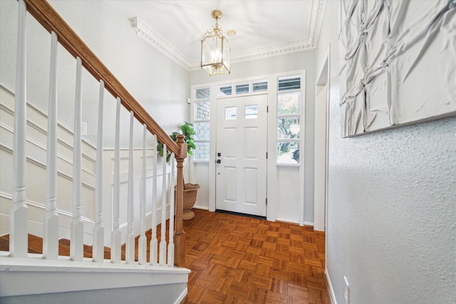 foyer featuring stairs, baseboards, a notable chandelier, and crown molding