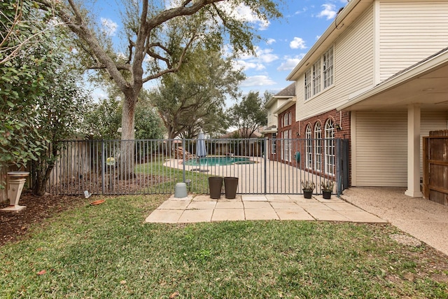 view of yard featuring a patio area, a fenced backyard, and a fenced in pool