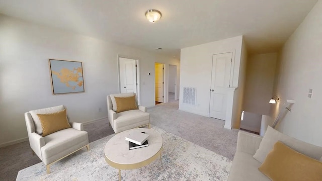 living area with carpet, visible vents, and baseboards