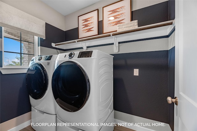 washroom featuring laundry area, independent washer and dryer, and baseboards