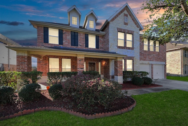 view of front of home featuring a garage, stone siding, driveway, and brick siding