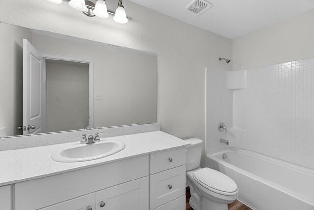 full bath featuring shower / washtub combination, visible vents, vanity, and toilet