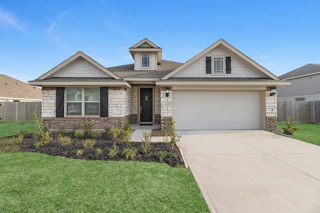 craftsman-style house featuring driveway, brick siding, fence, and a front yard