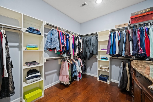 spacious closet with dark wood-type flooring and visible vents