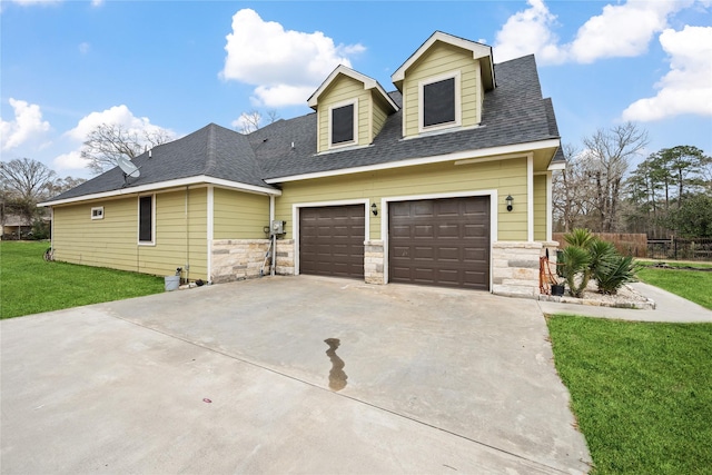 view of front facade with driveway, a garage, stone siding, roof with shingles, and a front lawn