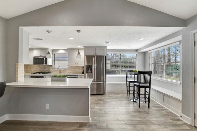 12203 W Morgan Dr, Houston, TX 77065 - kitchen with stainless steel appliances, light countertops, lofted ceiling, and a sink