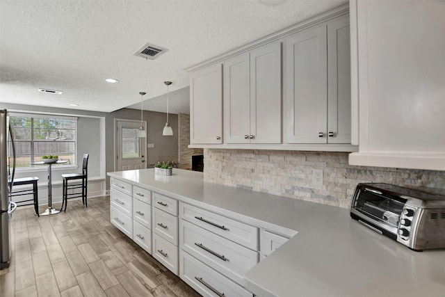 12203 W Morgan Dr, Houston, TX 77065 - kitchen with visible vents, pendant lighting, freestanding refrigerator, a toaster, and decorative backsplash