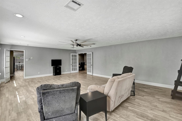 12203 W Morgan Dr, Houston, TX 77065 - living room with visible vents, french doors, and light wood-style floors
