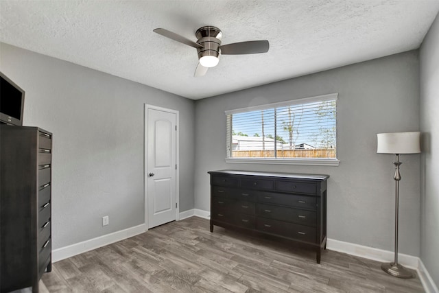 12203 W Morgan Dr, Houston, TX 77065 - bedroom with ceiling fan, wood finished floors, baseboards, and a textured ceiling
