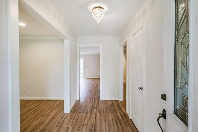 corridor with wood finished floors and baseboards