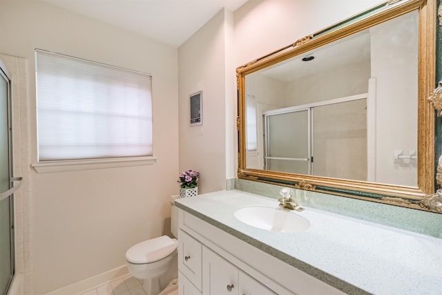 bathroom featuring tile patterned flooring, vanity, toilet, and an enclosed shower