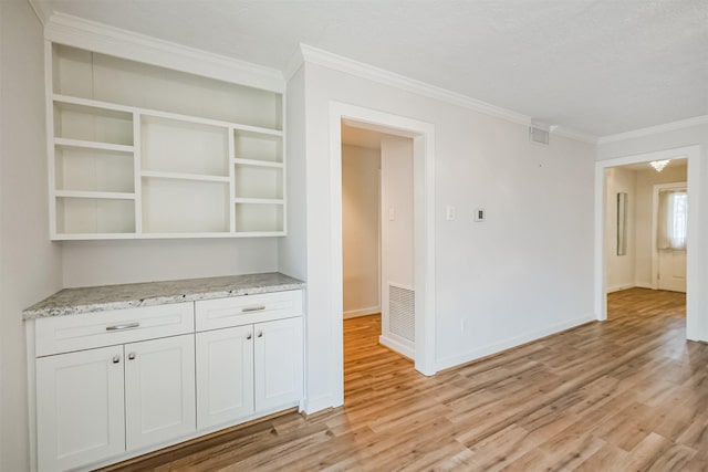 interior space featuring crown molding, open shelves, visible vents, light wood-style floors, and white cabinets