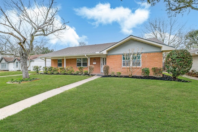 ranch-style house featuring brick siding and a front yard