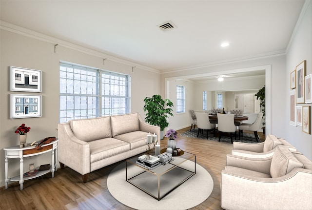 living area featuring visible vents, wood finished floors, and ornamental molding