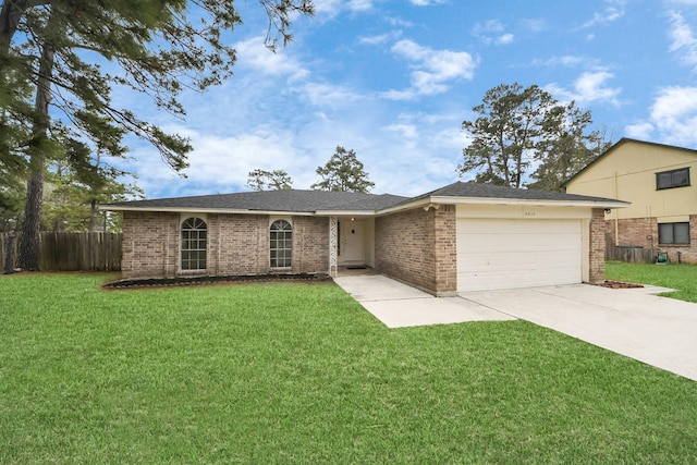 ranch-style home featuring driveway, a front lawn, an attached garage, and brick siding