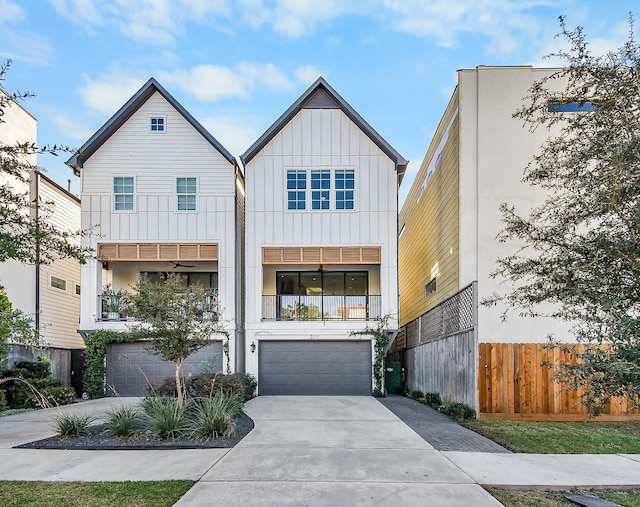 view of front of property with a garage, fence, board and batten siding, and concrete driveway