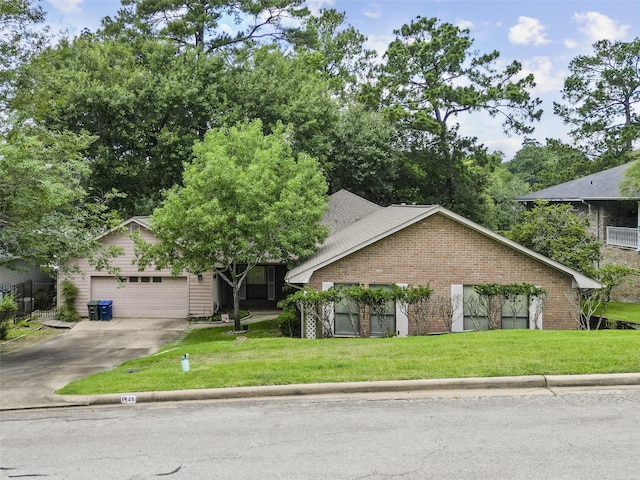 view of front of house featuring an attached garage, a front lawn, concrete driveway, and brick siding