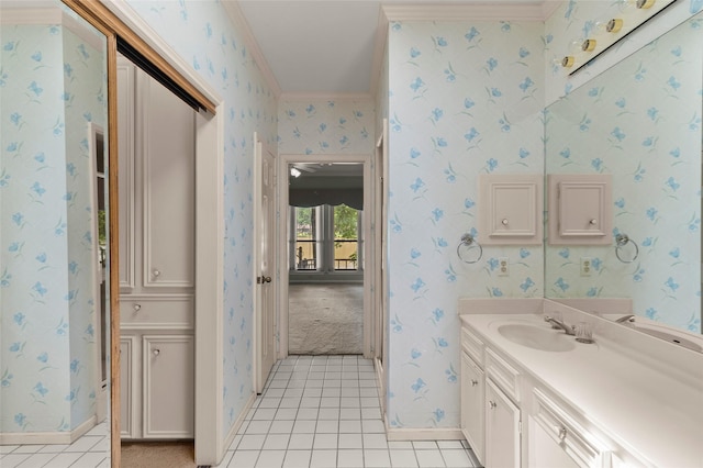 bathroom with crown molding, wallpapered walls, vanity, baseboards, and tile patterned floors