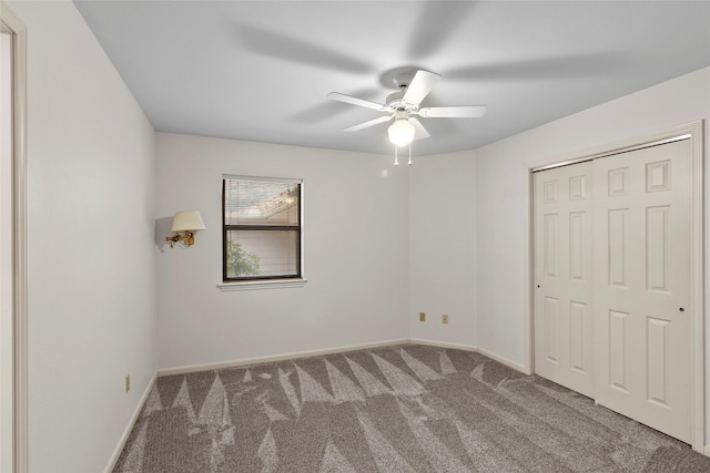 unfurnished bedroom featuring ceiling fan, a closet, baseboards, and carpet flooring