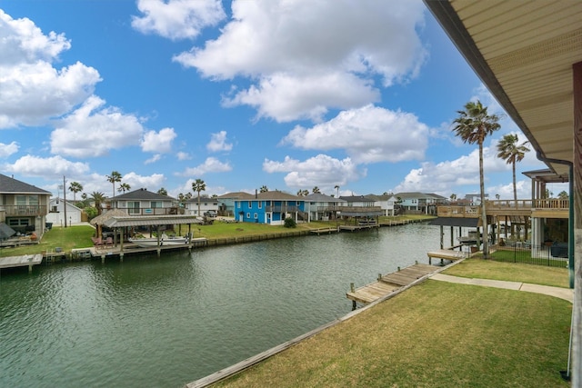 dock area featuring a residential view, a water view, and a lawn