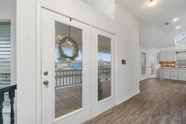 interior space with recessed lighting, wood finished floors, visible vents, baseboards, and vaulted ceiling