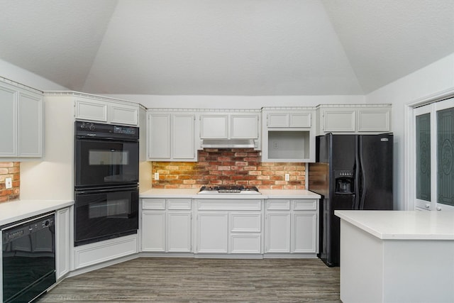kitchen featuring black appliances, white cabinetry, and light countertops