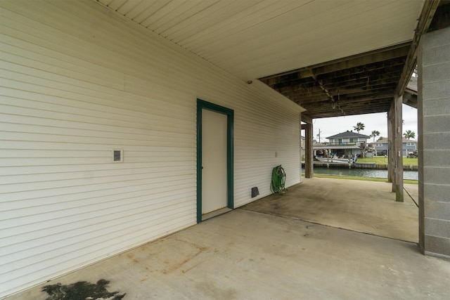 view of patio / terrace with a water view and a carport