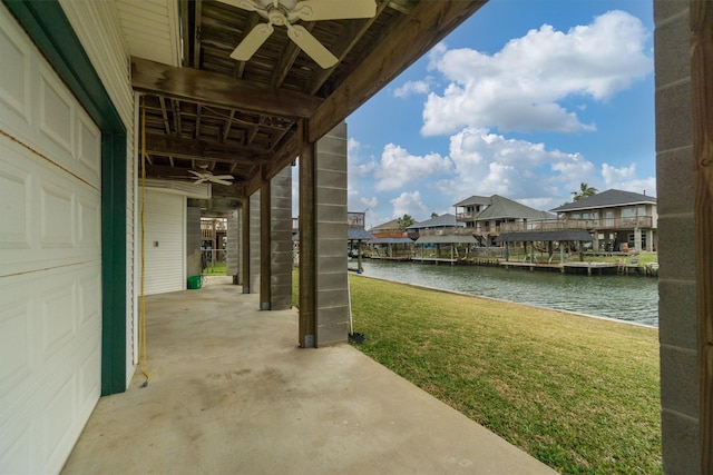 view of patio with a ceiling fan and a water view
