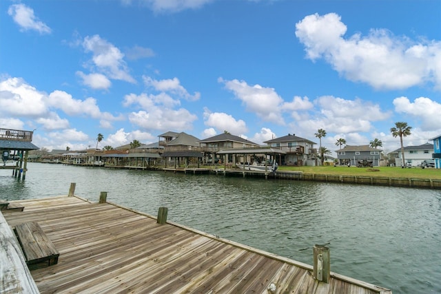 dock area featuring a water view and a residential view