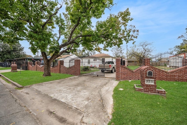 view of front facade with a gate, fence, and a front lawn