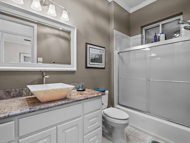 1250 Oahu Dr, Tiki Island, TX 77554 - full bath with crown molding, tile patterned flooring, vanity, combined bath / shower with glass door, and toilet