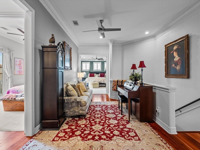 1250 Oahu Dr, Tiki Island, TX 77554 - living room featuring ornamental molding, a ceiling fan, light wood-type flooring, and visible vents