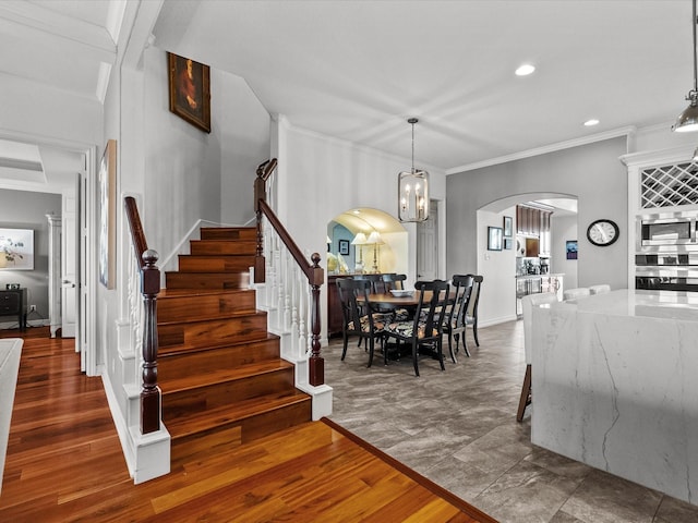 1250 Oahu Dr, Tiki Island, TX 77554 - interior space featuring crown molding, stairs, wood finished floors, recessed lighting, and arched walkways