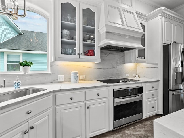 1250 Oahu Dr, Tiki Island, TX 77554 - kitchen featuring white cabinetry, appliances with stainless steel finishes, decorative backsplash, and glass insert cabinets