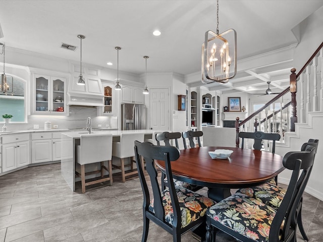 1250 Oahu Dr, Tiki Island, TX 77554 - dining area with crown molding, recessed lighting, visible vents, and ceiling fan with notable chandelier
