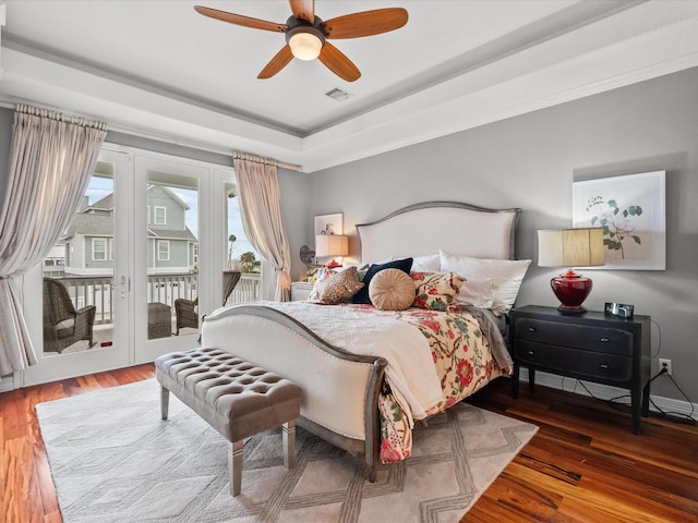 1250 Oahu Dr, Tiki Island, TX 77554 - bedroom with visible vents, access to exterior, french doors, and wood finished floors